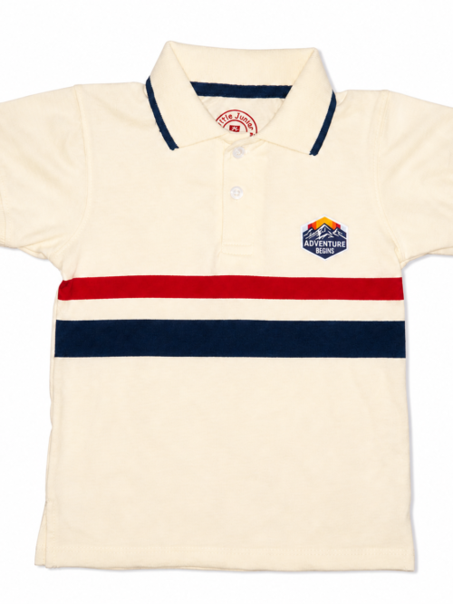 Light cream kids polo shirt with red and navy horizontal stripes, short sleeves, and a small “Adventure Begins” patch on the chest, displayed on a white background.