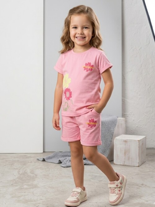 Happy 4 year old girl posing in Bachaa Squad pink cotton shorts and shirt outfit in a bright studio